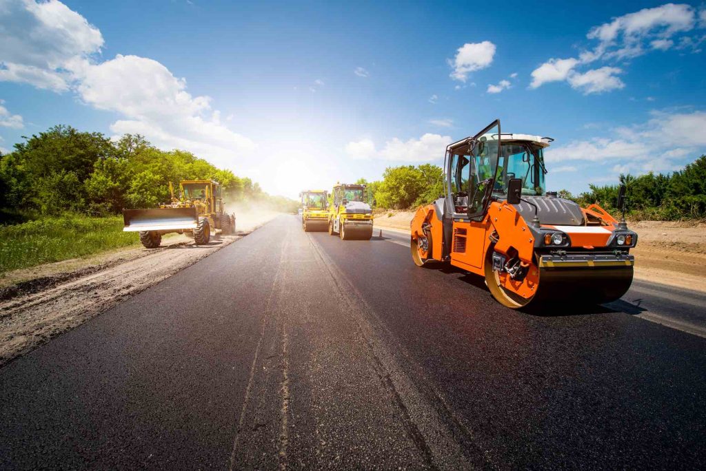 Rollers compacting a fresh asphalt road